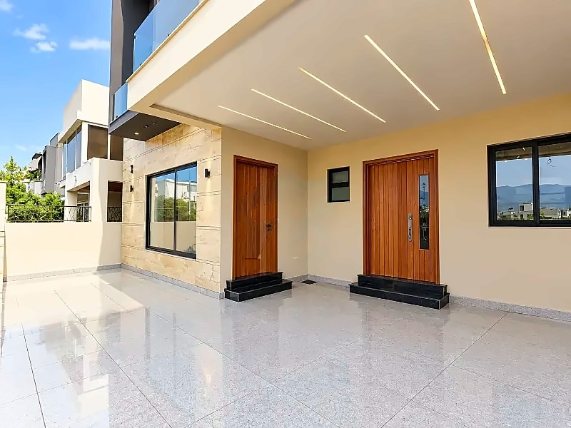 Covered entrance and tiled car porch of the D-12/2 double-unit house