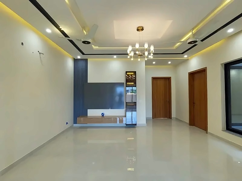 TV lounge with recessed lighting, ceiling fans and a feature wall in the D-12/2 house