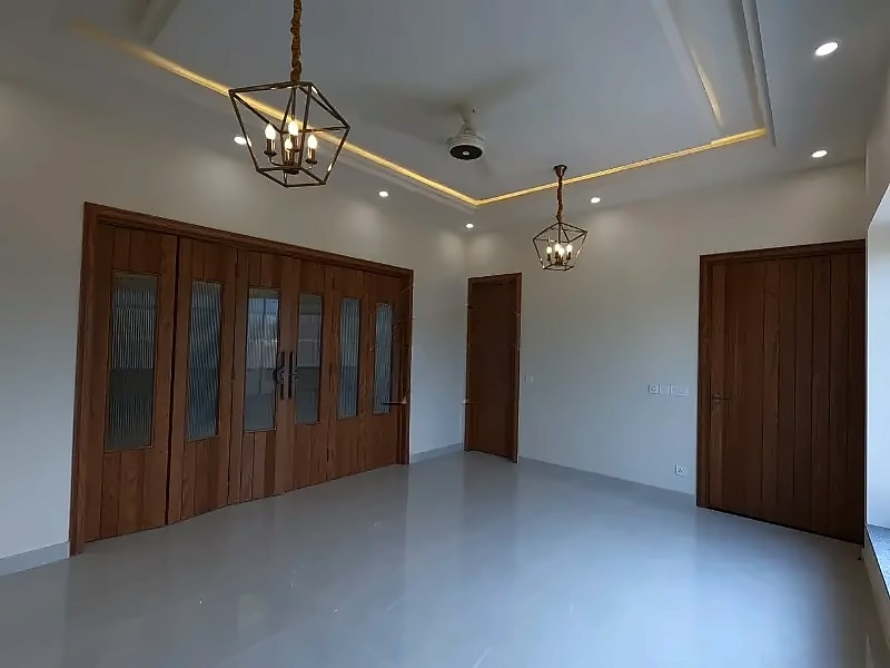 Room with fitted wooden storage and pendant lights in the D-12/2 house