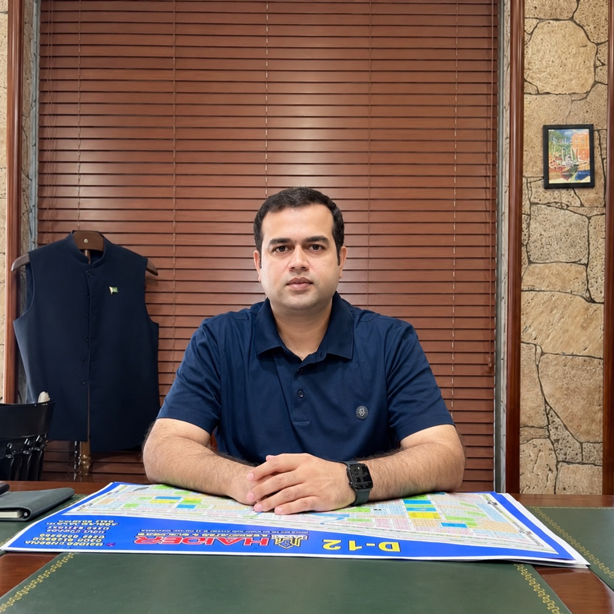 Haider Cheema, Founder & CEO of Haider Associates & Builders, at his office desk
